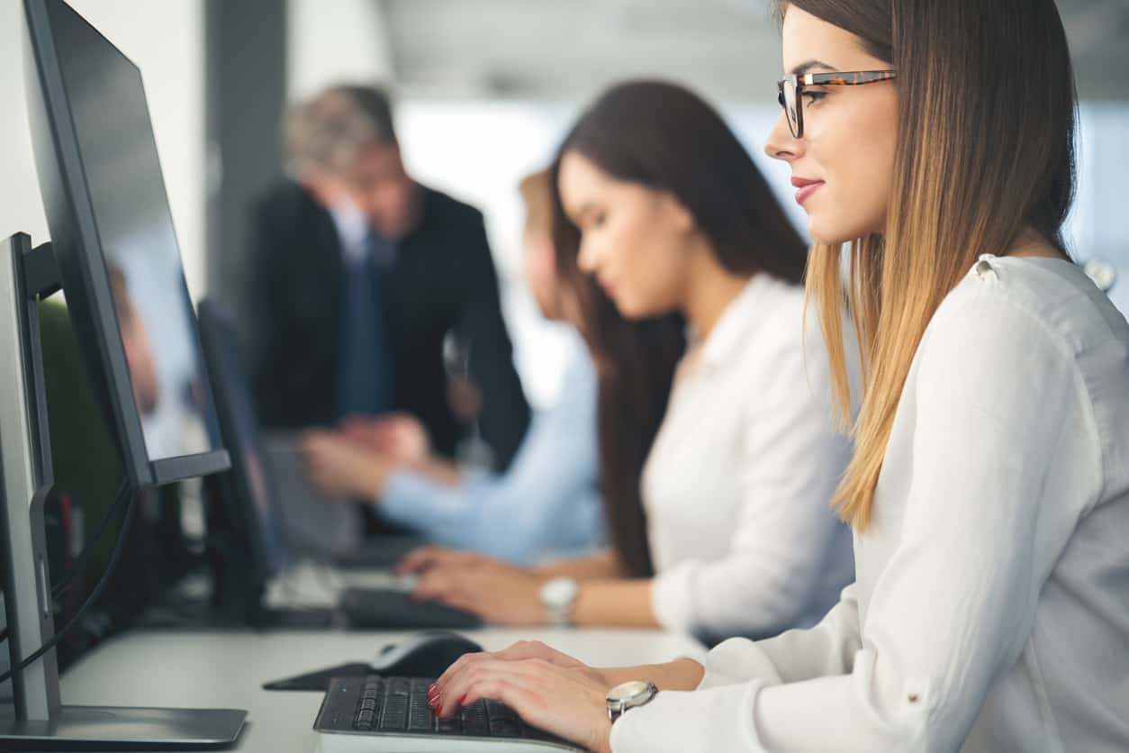 Woman Using Computer at Desk