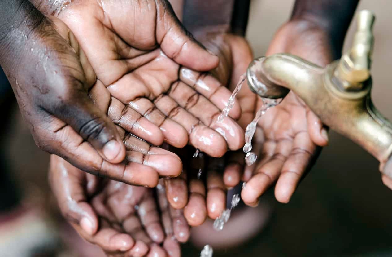 Lots of Hands Under Water Tap in Africa